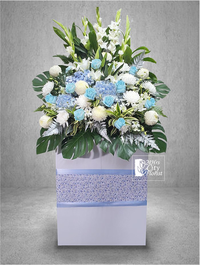 Click To Order gentle blue condolence flowers